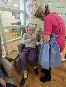 Kirby House care home resident, located in Leicestershire participating in animal therapy 