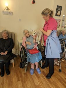 Kirby House Care Home resident interacting with the lamb